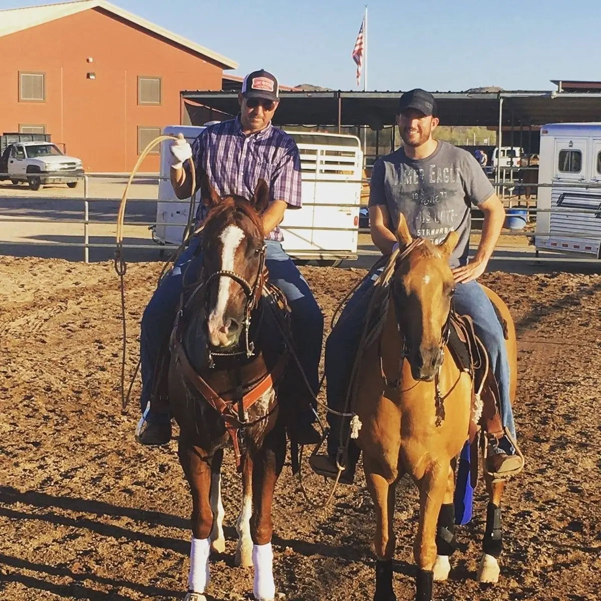 Powell Parker and Joel team roping in the arena